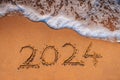 2024 New Year Number Handwritten On A Sandy Beach at Sunrise, travel concept background