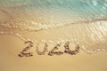 Happy New Year 2020 concept, 2020 number lettering on the sea beach. Royalty Free Stock Photo