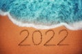 Happy New Year 2022 concept on the sea beach sand; sea sunrise Royalty Free Stock Photo