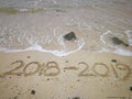 Happy new year concept, 2018 to 2019 written in the sand on a beach Royalty Free Stock Photo