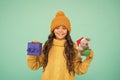 happy new 2020 year. cute santa mice toy gift. small girl hold mouse toy and present box. child knitted clothes play Royalty Free Stock Photo