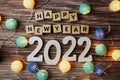 Happy New Year 2022 decorate with LED cotton ball on wooden background