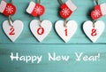 Happy New Year 2018.Decorative white wooden Christmas hearts and red mittens on blue wooden background with copy space. Royalty Free Stock Photo