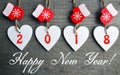 Happy New Year 2018.Decorative white wooden Christmas hearts and red mittens on old wooden background. Royalty Free Stock Photo