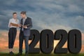 Happy New Year 2020 Digital Trend Concept,businessman and businesswoman stand to discuss company plans,goals and future planning Royalty Free Stock Photo