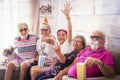 Happy new year eve celebration at home with young and senior people family having fun all together and looking on camera - Royalty Free Stock Photo