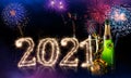 Happy new year eve colorful fireworks sparkler 2021 number four leaf clover champagne bottle glass front of red purple blue black Royalty Free Stock Photo