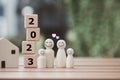 Human figure family with smiling face and heart with wooden blocks number 2023. 2023 Happy New Year. Happy family. Royalty Free Stock Photo