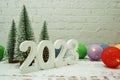 Happy New Year 2023 festive background with christmas tree on white brick wall background Royalty Free Stock Photo