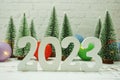 Happy New Year 2023 festive background with christmas tree on white brick wall background Royalty Free Stock Photo