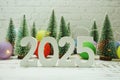 Happy New Year 2025 festive background with christmas tree on white brick wall background