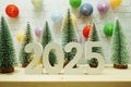 Happy New Year 2025 festive background with christmas tree on white brick wall background
