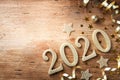 Happy New Year festive background with golden numbers 2020 and Christmas decorations on vintage wooden table top view Royalty Free Stock Photo