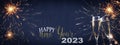 HAPPY NEW YEAR 2023 - Festive silvester background panorama banner long - Golden yellow firework and two champagne classes Royalty Free Stock Photo