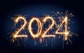 HAPPY NEW YEAR 2024 - Festive silvester New Year`s Eve Party background greeting card - Golden fireworks in the dark blue night Royalty Free Stock Photo