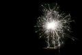 Happy New Year, festive, white sparkling burning sparkler or salute on a black background. Holiday concept, copy space. Royalty Free Stock Photo