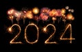 2024 happy new year fireworks celebration written sparkling at night Royalty Free Stock Photo