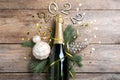 Happy New Year 2022! Flat lay composition with bottle of sparkling wine on wooden table Royalty Free Stock Photo