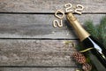 Happy New Year 2022! Flat lay composition with bottle of sparkling wine on wooden table, space for text Royalty Free Stock Photo