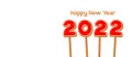 Happy New Year 2022. Gingerbread cookies with red icing in the form of the number 2022 on sticks on a white background