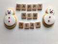 Happy New Year and gingerbread snowman cookies on white Royalty Free Stock Photo