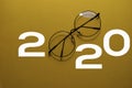 Happy New Year 2020 with Glasses isolated on yellow background