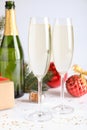 Happy New Year! Glasses of sparkling wine and festive decor on white background