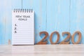 2020 Happy New Year Goals word on notebook and wooden number. time for a New Start, Resolution, Plan, Action and Mission Concept