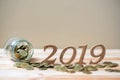 2019 Happy New Year with gold coins stack and wooden number on table. business, investment, retirement planning, finance, Saving a Royalty Free Stock Photo