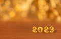 Happy new year 2023. Golden numbers on a shiny background