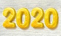 Happy New Year 2020. Golden numbers on white wooden background