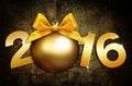 Happy new year 2016 golden text with ball in grunge background