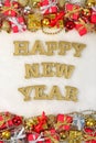 Happy New Year golden text and Christmas decorations on a white Royalty Free Stock Photo