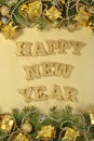 Happy New Year golden text and spruce branch and Christmas decor Royalty Free Stock Photo