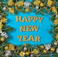 Happy New Year golden text and spruce branch and Christmas decor Royalty Free Stock Photo