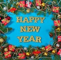 Happy New Year golden text and spruce branch and Christmas decor Royalty Free Stock Photo