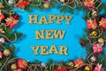 Happy New Year golden text and spruce branch and Christmas decor Royalty Free Stock Photo