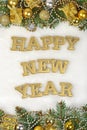 Happy New Year golden text and spruce branch and Christmas decor Royalty Free Stock Photo