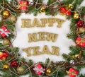 Happy New Year golden text and spruce branch and Christmas decor Royalty Free Stock Photo