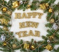 Happy New Year golden text and spruce branch and Christmas decor Royalty Free Stock Photo