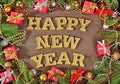 Happy New Year golden text and spruce branch and Christmas decor Royalty Free Stock Photo