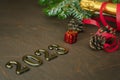 Happy new year 2023 greeting card on a brutal metal background with a branch of a Christmas tree, bright lights and a bottle of Royalty Free Stock Photo