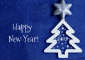 Happy New Year greeting card.White christmas tree with 2019 number on a dark blue wooden background. Royalty Free Stock Photo