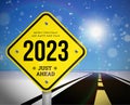 Happy new year 2023 greetings with road sign on the background of the road going into the distance planning concept and goals Royalty Free Stock Photo