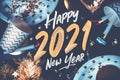2021 happy new year hand brush storke font on marble table with party cup,party blower,tinsel,confetti.Fun Celebrate holiday party