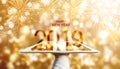 Happy New Year 2019, Hand holding digital tablet with luxury gold Bokeh fireworks background Royalty Free Stock Photo