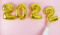 Happy new year 2022. Hand with white sleeve placing the number 2. Copy space Royalty Free Stock Photo