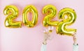 Happy new year 2022. Hands with cups and holding the number 2. Copy space Royalty Free Stock Photo