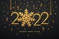 Happy New 2022 Year. Hanging Golden metallic numbers 2022 with shining snowflake and confetti on black background. New Year Royalty Free Stock Photo