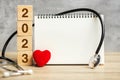 2023 Happy New Year for healthcare, Insurance, Wellness and medical concept. Stethoscope and blank notebook for copy space your